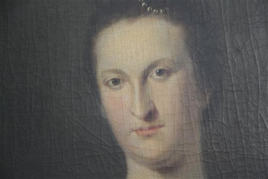 Early 18th Century English School Portrait of a lady wearing a blue dress and pearls in her hair 27 x 21in.